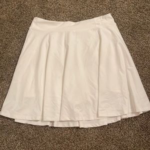 Fabletics white golf/tennis skort. Spandex attached underneath. Never worn